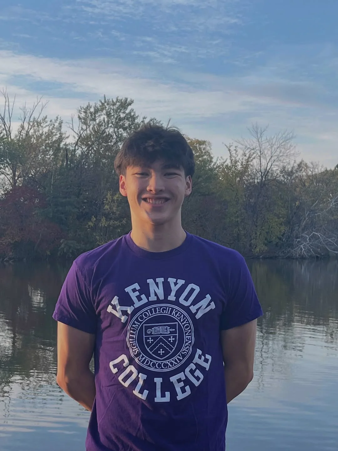 Ashton Boeke wearing a Kenyon College shirt beside a pond