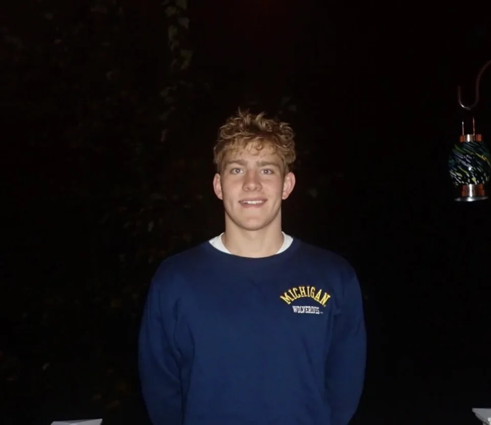Tyler Kominski wearing a Michigan Wolverines sweatshirt